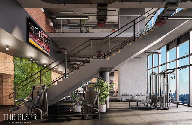 workout area featuring brick wall and a towering ceiling