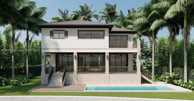 view of front of home with a garage, a balcony, and a front yard