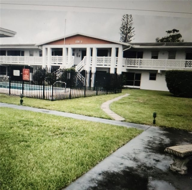 view of community with a pool and a yard