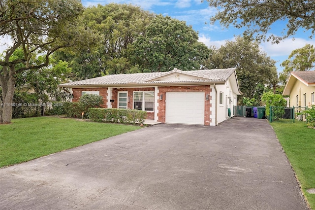 view of front of house featuring a front yard and a garage