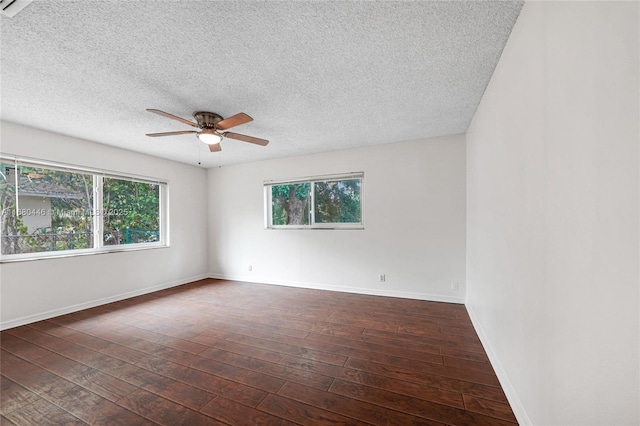 unfurnished room featuring dark hardwood / wood-style floors, ceiling fan, and a textured ceiling