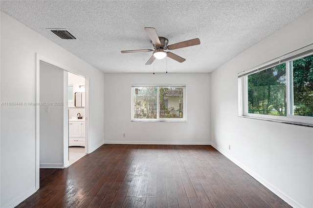 spare room featuring a textured ceiling, ceiling fan, sink, and dark hardwood / wood-style floors