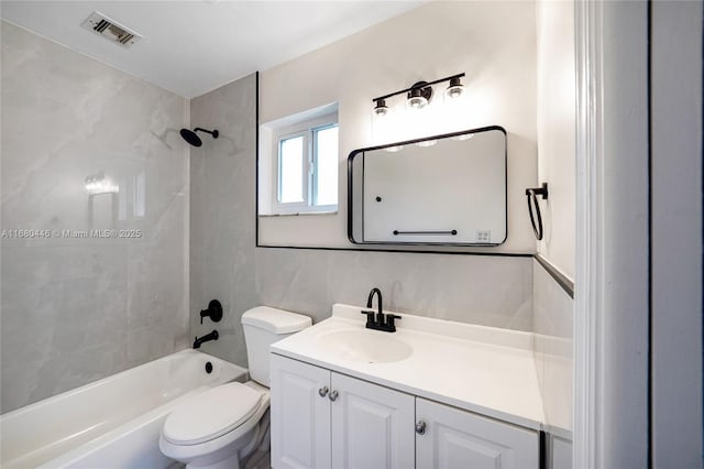 full bathroom with backsplash, vanity, tiled shower / bath combo, tile walls, and toilet