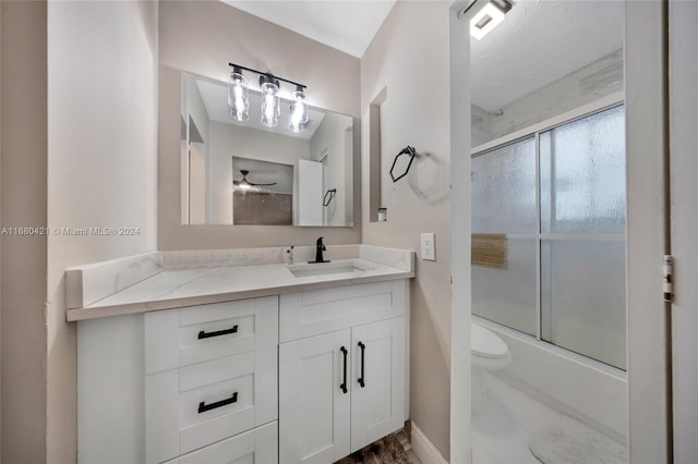 full bathroom with vanity, toilet, and enclosed tub / shower combo