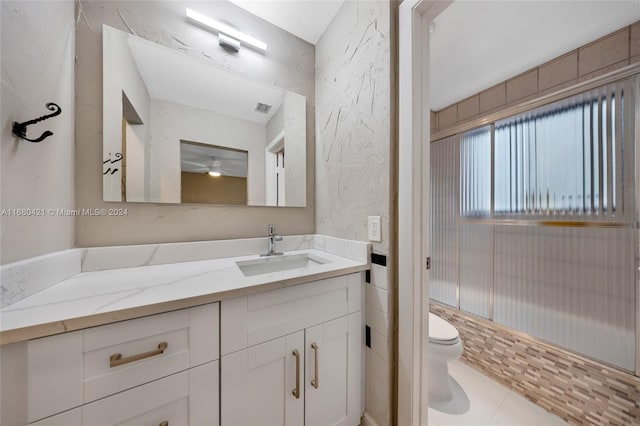 bathroom featuring toilet, vanity, and tile patterned floors