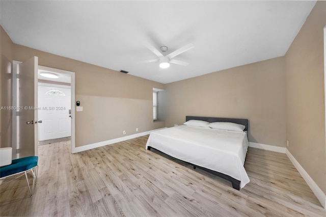 bedroom with light hardwood / wood-style flooring and ceiling fan