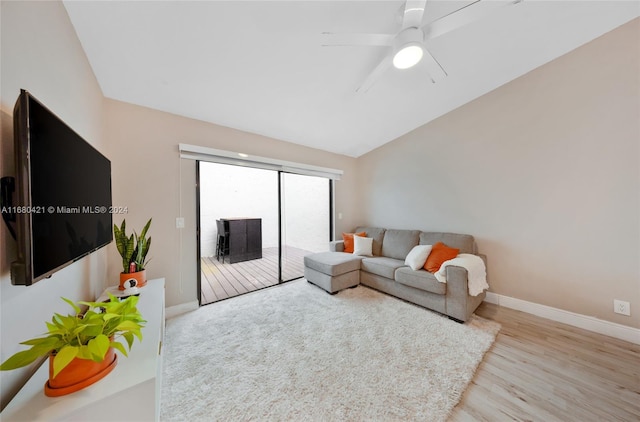 living room featuring light hardwood / wood-style flooring, lofted ceiling, and ceiling fan