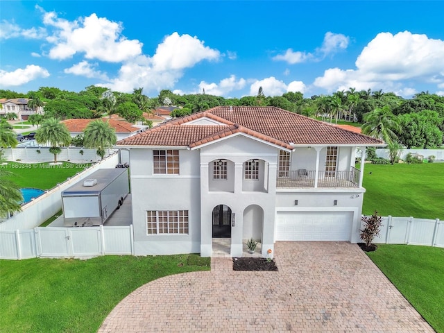 mediterranean / spanish house featuring a front lawn and a garage