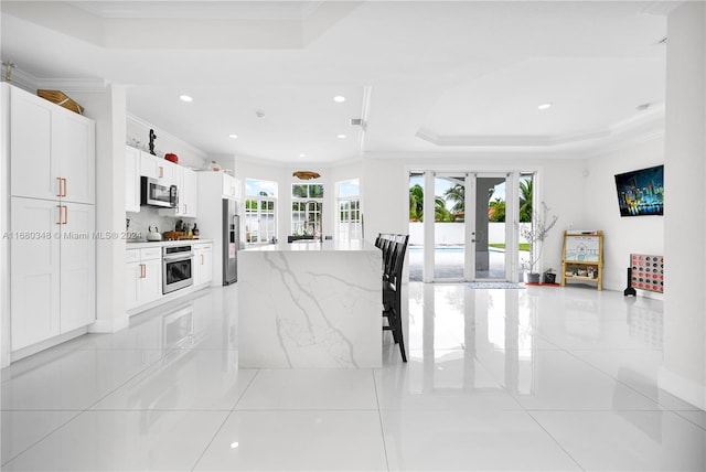 interior space with french doors, crown molding, and a tray ceiling