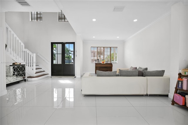 tiled living room with french doors and ornamental molding