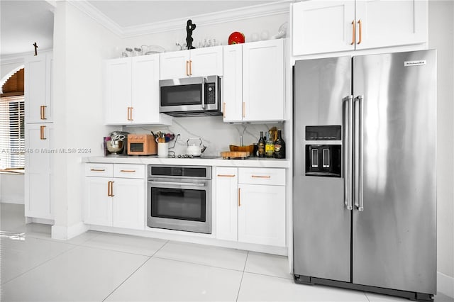 kitchen with white cabinetry, stainless steel appliances, and light tile patterned floors