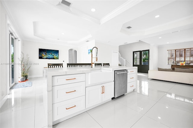 kitchen featuring sink, dishwasher, white cabinetry, and a tray ceiling