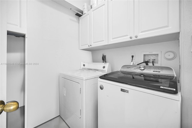 laundry room with cabinets and washing machine and clothes dryer