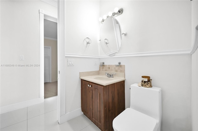 bathroom with vanity, toilet, crown molding, and tile patterned floors