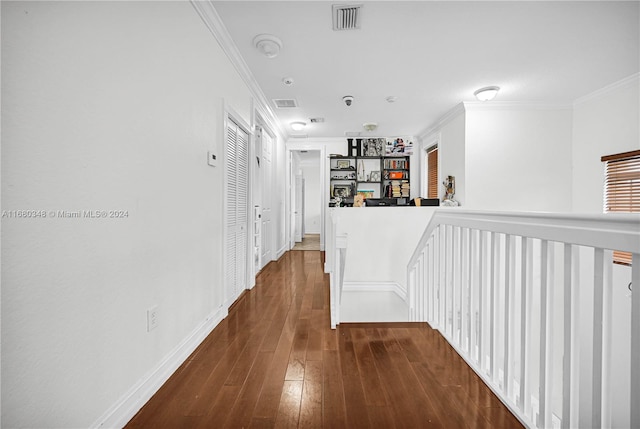 corridor featuring crown molding and dark hardwood / wood-style flooring