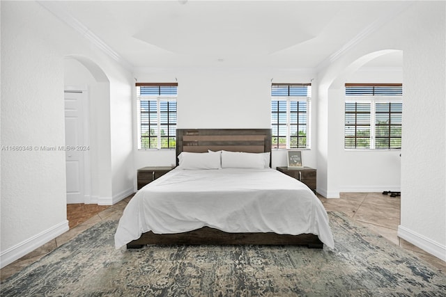 bedroom with multiple windows and crown molding