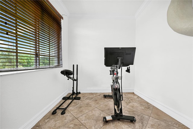 exercise area featuring ornamental molding and light tile patterned flooring