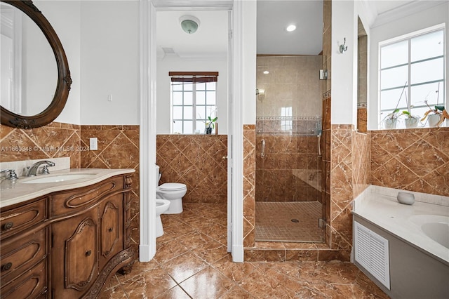 bathroom featuring a shower with shower door, toilet, tile walls, vanity, and a bidet