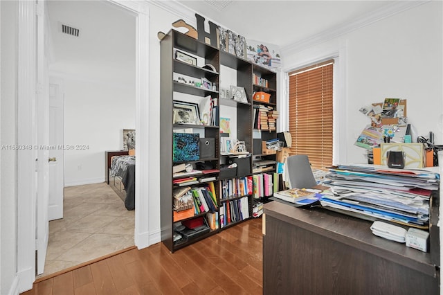 home office featuring crown molding and hardwood / wood-style floors