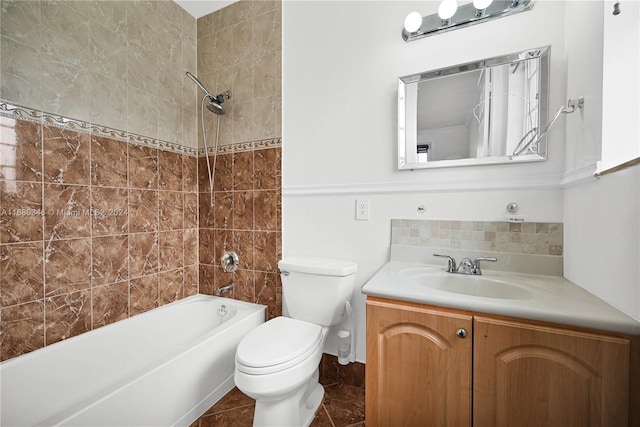 full bathroom featuring tiled shower / bath, vanity, toilet, and tile patterned floors