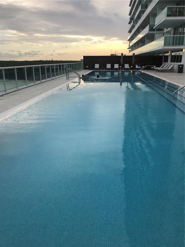 pool at dusk with a water view