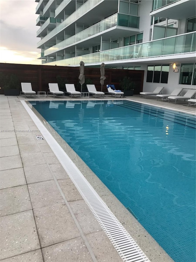 view of pool at dusk