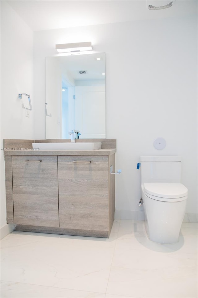 bathroom featuring vanity, toilet, and tile patterned floors