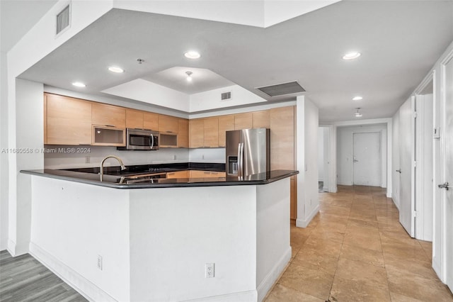 kitchen featuring appliances with stainless steel finishes and kitchen peninsula