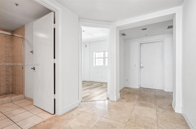 hallway featuring light tile patterned floors