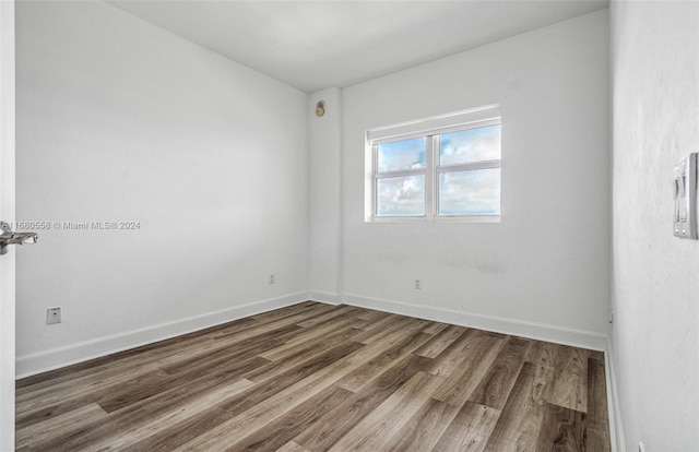 empty room with dark wood-type flooring