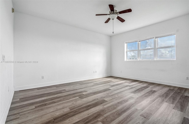 unfurnished room with hardwood / wood-style flooring and ceiling fan