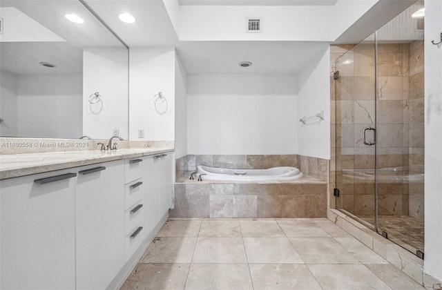 bathroom featuring vanity, plus walk in shower, and tile patterned flooring