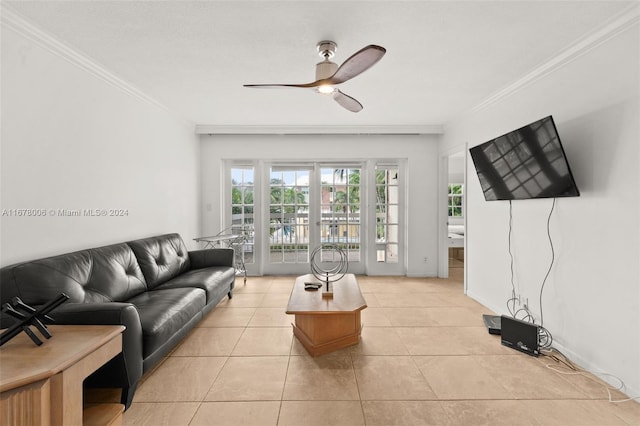 living room featuring ornamental molding, light tile patterned flooring, and ceiling fan