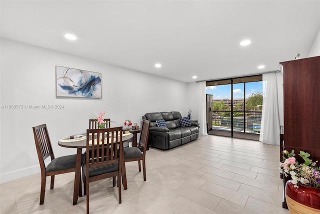 dining space featuring a wall of windows