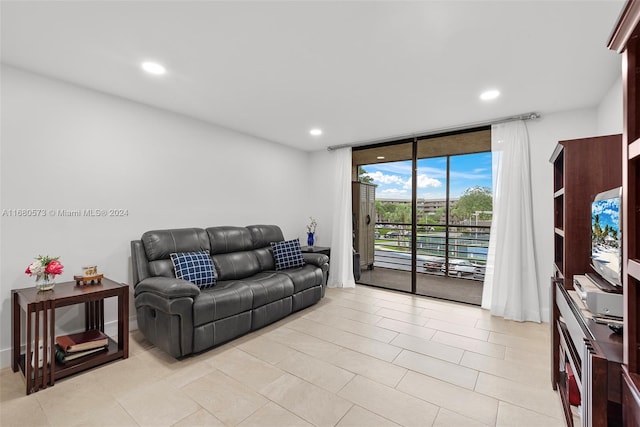 tiled living room featuring expansive windows