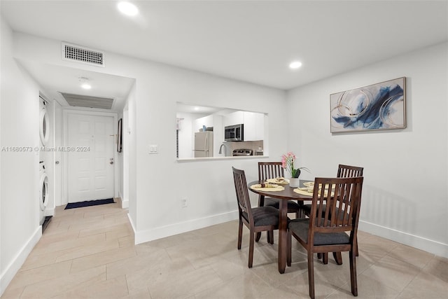 dining room with stacked washing maching and dryer