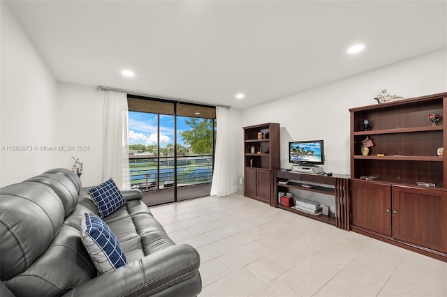 living room with expansive windows and light tile patterned flooring