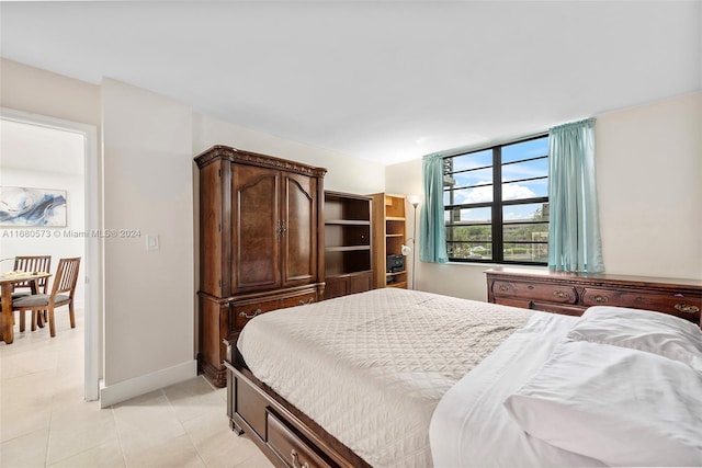 bedroom with light tile patterned floors