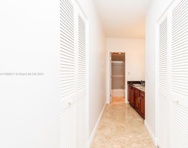 hallway with sink and light tile patterned floors