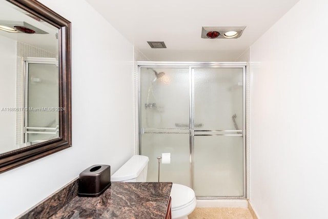 bathroom with vanity, toilet, and an enclosed shower