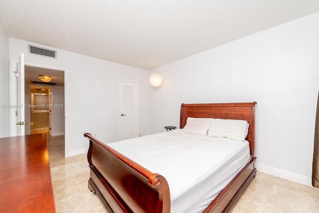 bedroom with a closet and a textured ceiling