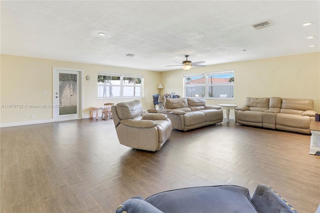 living room with light hardwood / wood-style flooring and ceiling fan