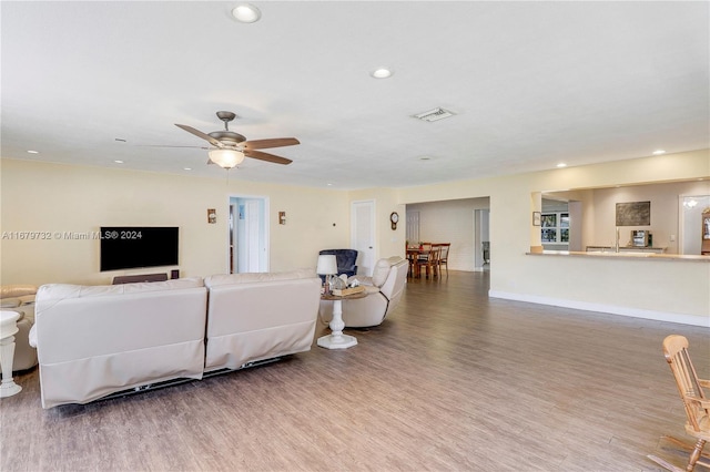 living room featuring hardwood / wood-style flooring and ceiling fan