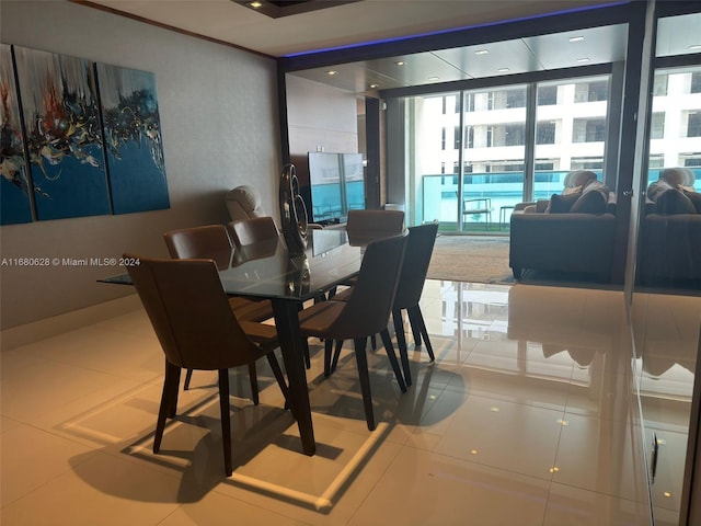 tiled dining area featuring expansive windows