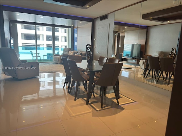 tiled dining area with expansive windows