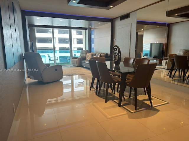 tiled dining space with expansive windows