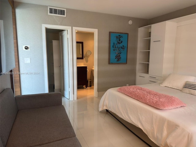 tiled bedroom featuring ensuite bathroom