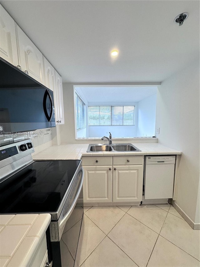 kitchen with sink, stainless steel electric range, dishwasher, and white cabinets