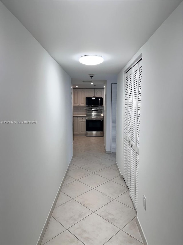 hallway featuring light tile patterned flooring