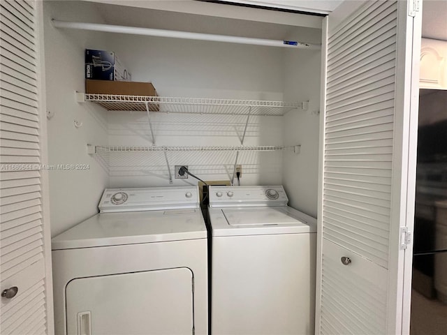 laundry room with washing machine and clothes dryer